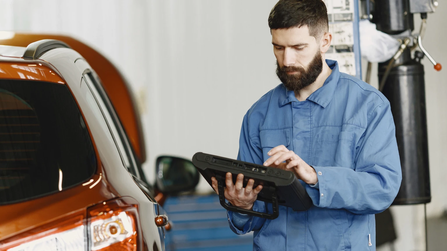 Technician reviewing vehicle information on a workshop tablet