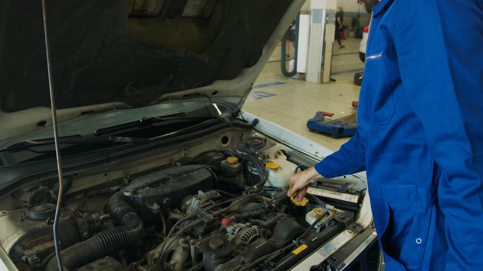 Mechanic inspecting an engine during a diagnostic check