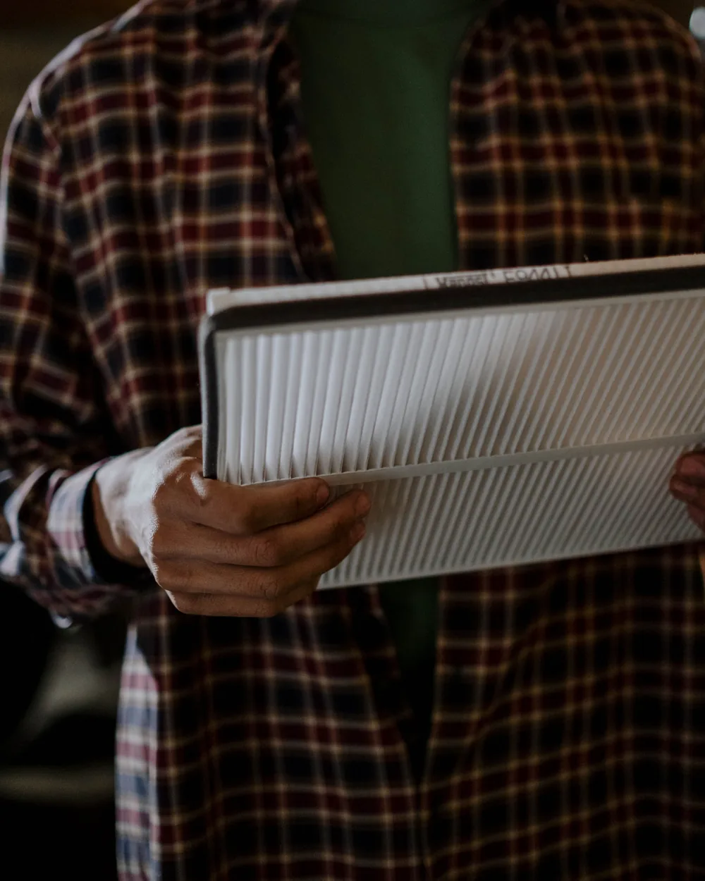 A new cabin air filter held in an automotive workshop