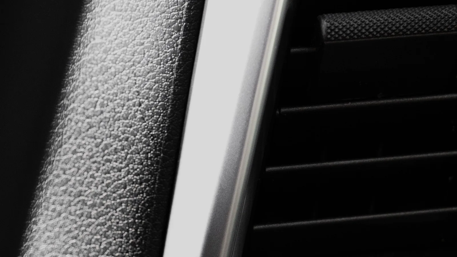 Close view of an unbranded vehicle dashboard air vent