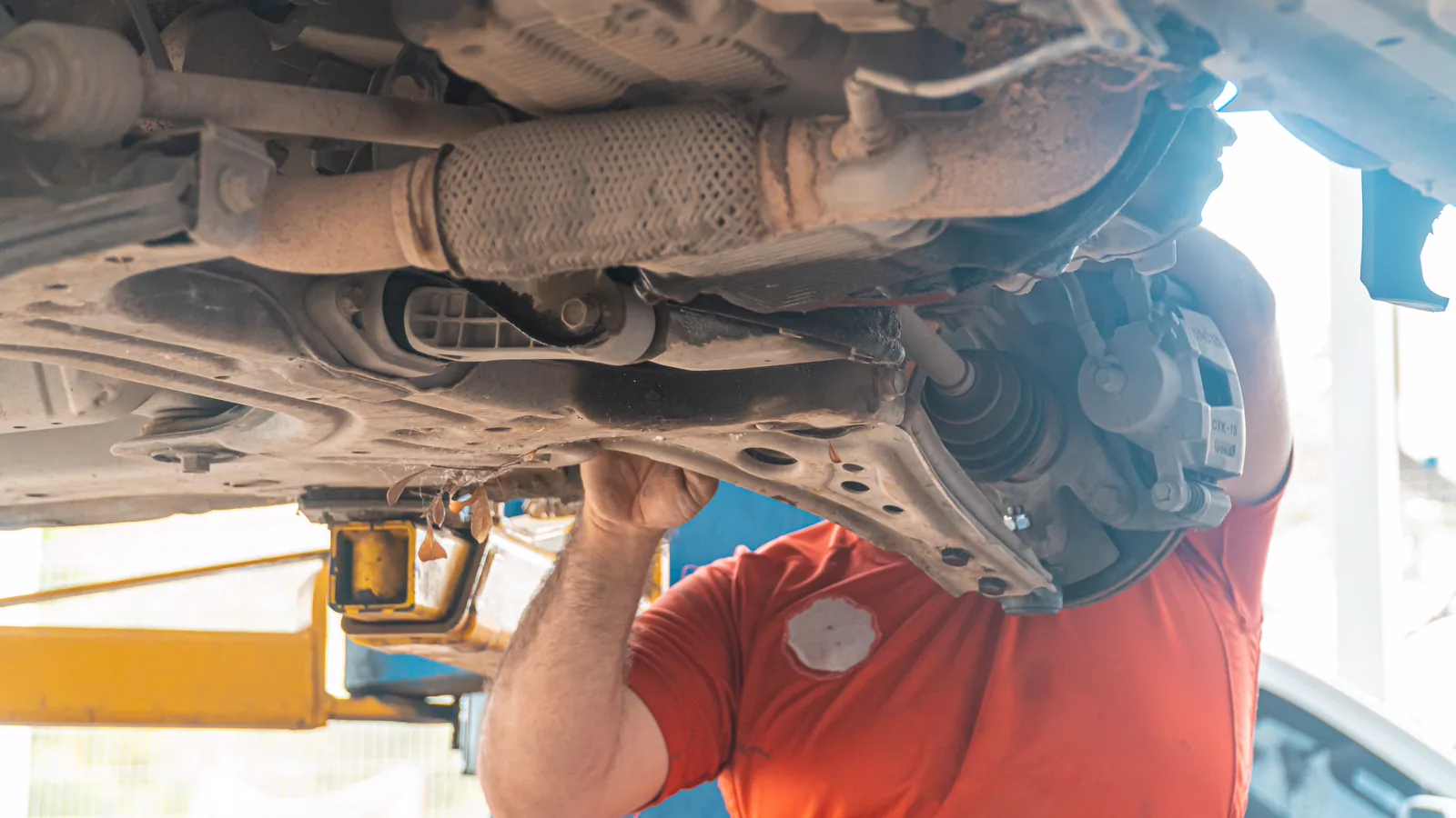 Underside of a vehicle raised for suspension inspection