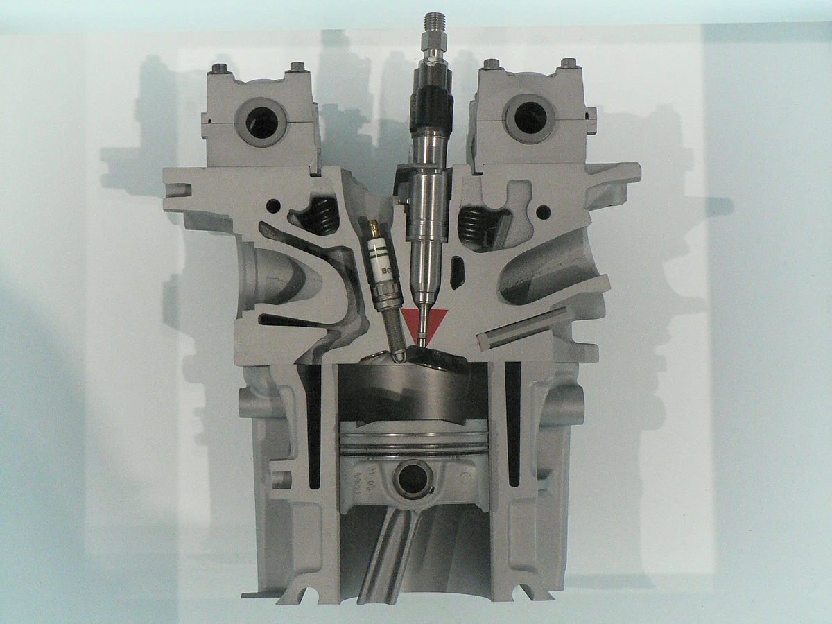 Cutaway of a BMW gasoline direct-injection engine showing an injector entering the combustion chamber